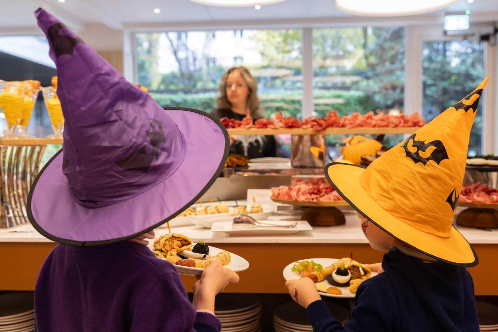 Halloween buffet with witch hats and charcuterie